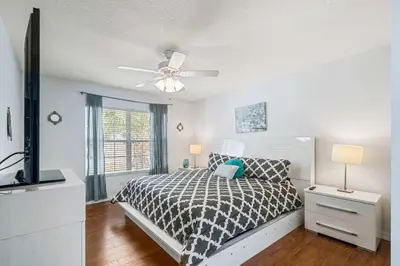 a bedroom with a bed and a ceiling fan at 7 Bed Family Villa for All in Kissimmee