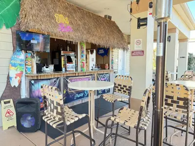 a table and chairs in front of a restaurant at 4 Bedroom 3 Bathroom Villas At SevenDwarfs 4-108 in Kissimmee