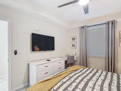 a bedroom with a bed and a flat screen tv at Storey Lake Beautiful 2-BR Condo, Resort Amenities in Kissimmee