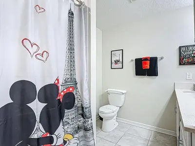 a bathroom with a shower curtain with the eiffel tower at Storey Lake Beautiful 2-BR Condo, Resort Amenities in Kissimmee