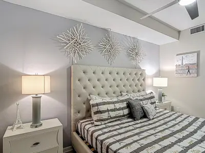 a bedroom with a large bed and two lamps at Storey Lake Beautiful 2-BR Condo, Resort Amenities in Kissimmee