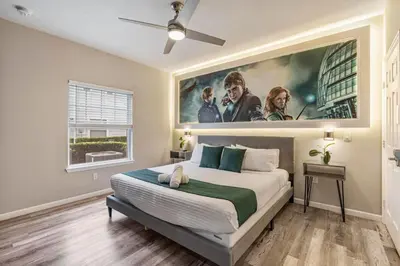 a bedroom with a large painting on the wall at Thematic 4 bdr near Disney-22101 in Kissimmee