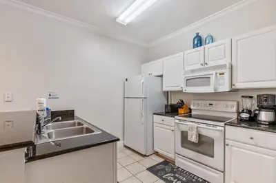 a kitchen with white appliances and a sink at Cozy 3BDR house near Disney in Kissimmee