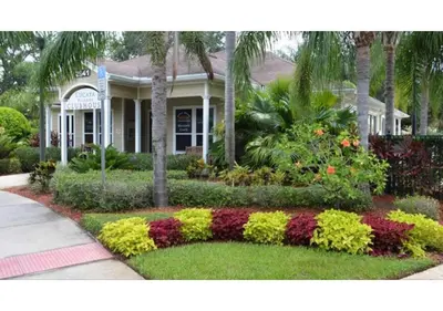 a house with a flower garden in front of it at Cozy 3BDR house near Disney in Kissimmee