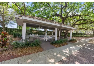a pavilion with a table and chairs on a sidewalk at Cozy 3BDR house near Disney in Kissimmee