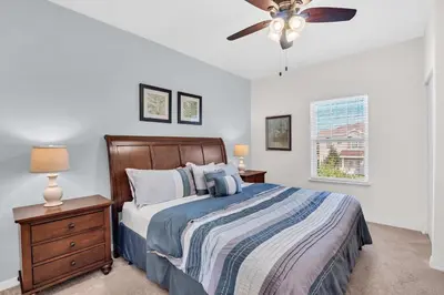 a bedroom with a bed and a ceiling fan at Your Disney Vacation Home WL8932 in Kissimmee