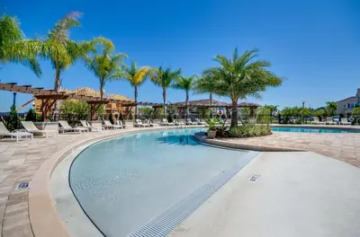 a swimming pool at a resort with palm trees at Your Disney Vacation Home WL8932 in Kissimmee