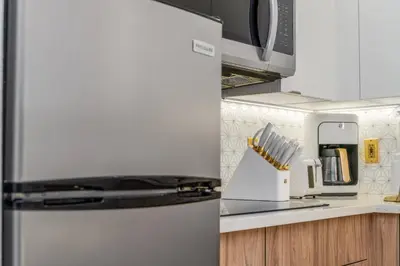 a kitchen with a refrigerator and a microwave at Orlando 2BR Apt Full Kitchen Near Parks in Orlando