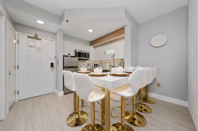 a kitchen and dining room with a white table and chairs at Orlando 2BR Apt Full Kitchen Near Parks in Orlando