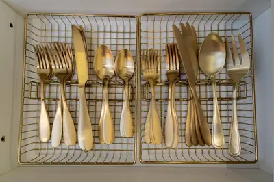 a rack with goldoons and forks and spoons at Orlando 2BR Apt Full Kitchen Near Parks in Orlando