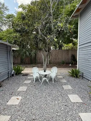 a patio with a table and two chairs and a tree at Cute and Cozy Apt Near Historic Downtown Sanford in Sanford