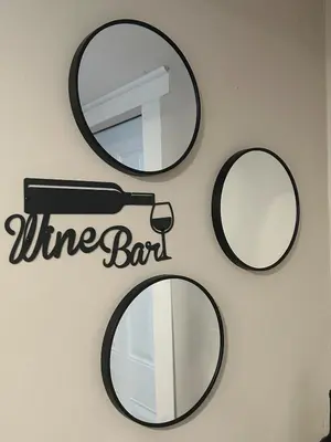 a wall with three mirrors and a wine bar sign at Cute and Cozy Apt Near Historic Downtown Sanford in Sanford