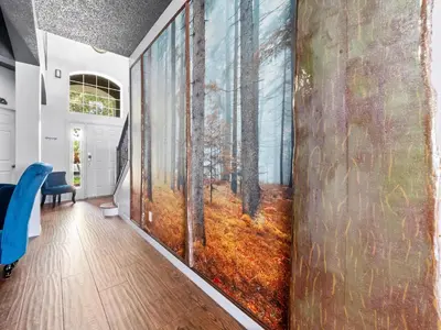 a hallway with a wall mural of a forest at bsv_villa8513 in Kissimmee