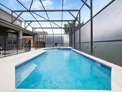 an indoor pool with blue water in a building at bsv_villa8513 in Kissimmee