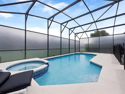 an indoor swimming pool with a glass roof at bsv_villa8513 in Kissimmee