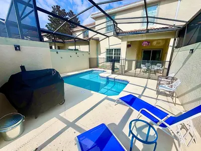 a house with a swimming pool and chairs in front of it at Disney Themed Home l Private Pool l Lazy River in Kissimmee