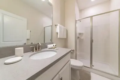a bathroom with a sink and a toilet and a shower at 4827#2 Casa com Quartos Temáticos e Piscina Privativa in Kissimmee