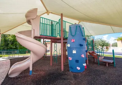 a childrens playground with a slide and a slide at Kissimmee Vacation Beautiful Home in Kissimmee