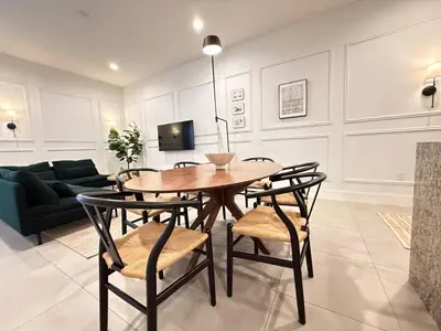a dining room with a table and chairs and a couch at Magical 4BR Escape - Pet-Friendly, 9 Min to Disney in Orlando