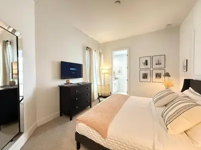 a bedroom with a bed and a flat screen tv at Magical 4BR Escape - Pet-Friendly, 9 Min to Disney in Orlando