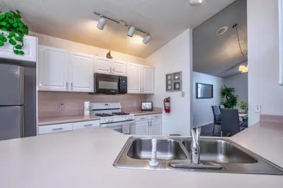 a kitchen with a sink and a counter top at Waterfront Privacy On Disneys Doorstep, Spa!2101O in Orlando