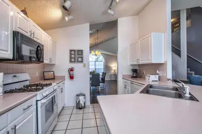 a kitchen with a sink and a stove top oven at Waterfront Privacy On Disneys Doorstep, Spa!2101O in Orlando