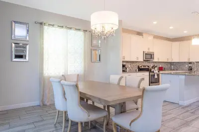 a dining room with a wooden table and chairs at Rare!Lake Front Pool-Spa, Close To Clubhouse-1691C in Kissimmee
