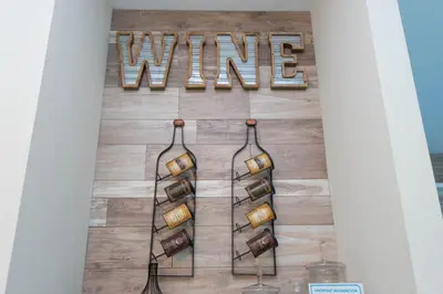 a wine wall with wine bottles and wine glasses at Rare!Lake Front Pool-Spa, Close To Clubhouse-1691C in Kissimmee