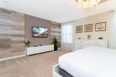 a bedroom with a white bed and a white dresser at Rare!Lake Front Pool-Spa, Close To Clubhouse-1691C in Kissimmee
