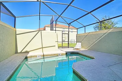 a swimming pool in a house with a glass roof at Paradise Palms-5 Bed Townhome Wsplashpool-3045Pp in Kissimmee