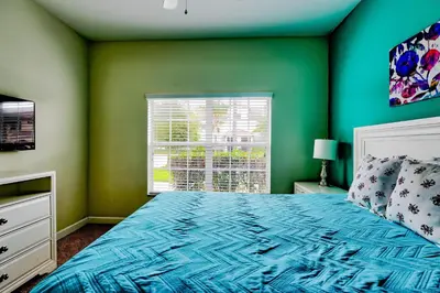 a green bedroom with a bed and a window at Bright Cheery Vacation Villa-1638St in Kissimmee