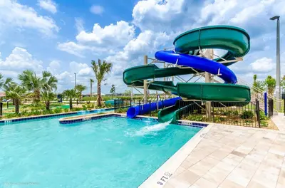 a water slide in a pool at a resort at Bright Cheery Vacation Villa-1638St in Kissimmee