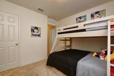 a bedroom with a bunk bed with stuffed animals on it at Charming Waterfront Townhome - 1954Cy in Kissimmee