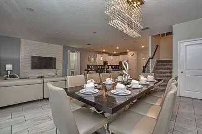 a dining room and kitchen with a table and chairs at Luxury Home Close To Disney, Bbq, Spa-1690St in Kissimmee