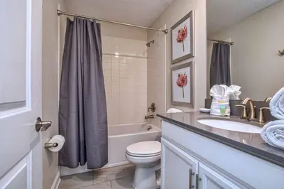 a bathroom with a toilet and a sink and a shower at Luxury Home Close To Disney, Bbq, Spa-1690St in Kissimmee