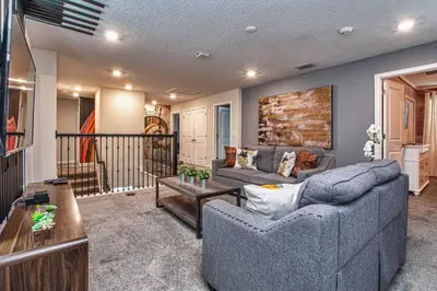 a living room with a couch and a table at Luxury Home Close To Disney, Bbq, Spa-1690St in Kissimmee