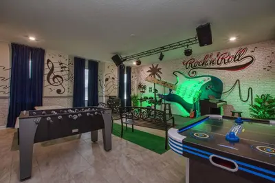 a room with a pool table and a wall with graffiti at Storey Lake 8 Bed Lake Front Pool Spa - 1684Str in Kissimmee