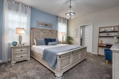 a bedroom with a large bed with blue walls at Storey Lake 8 Bed Lake Front Pool Spa - 1684Str in Kissimmee