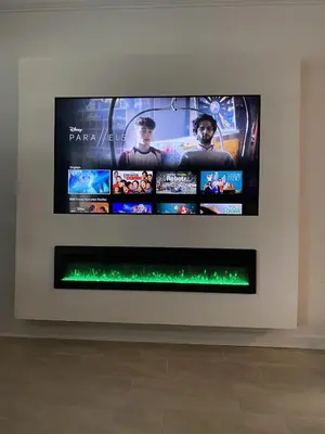 a flat screen tv hanging on a wall at Beautiful Brand New Waterfront Retreat!1689St in Kissimmee