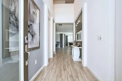 a hallway with a wooden floor and a door at Sonoma - 6 Bedroom Pool Home- 1859Snr in Kissimmee