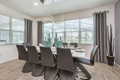 a dining room with a table and chairs at Sonoma - 6 Bedroom Pool Home- 1859Snr in Kissimmee