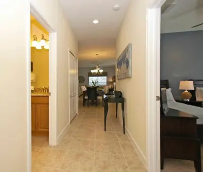 a hallway leading to a dining room and a living room at Paradise Palms- 5 Bed Townhome Wsplashpool-3020Pp in Kissimmee