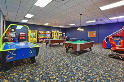 a room with several arcade games and pool tables at Paradise Palms- 5 Bed Townhome Wsplashpool-3020Pp in Kissimmee
