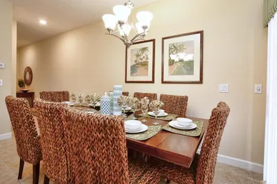 a dining room with a wooden table and chairs at Dog Friendly Townhouse With Splashpool 3610Pp in Kissimmee