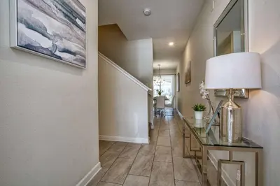 a hallway with a table and a lamp on a desk at Modern Decor, Waterview With Splashpool, Bbq 1636Str in Kissimmee