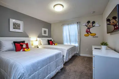 a bedroom with two beds and a mickey mouse mural at Modern Decor, Waterview With Splashpool, Bbq 1636Str in Kissimmee