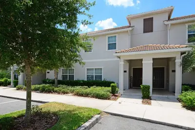 a white house with a tree and a street at Modern Decor, Waterview With Splashpool, Bbq 1636Str in Kissimmee