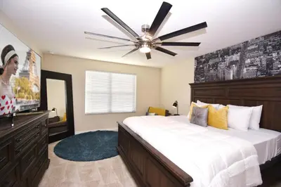 a bedroom with a large bed and a ceiling fan at Family Friendly Home W Game Room 1705Vp in Kissimmee