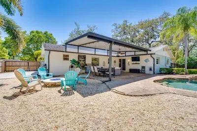 a patio with chairs and a table and a pool at Private Outdoor Oasis with Pool Home in Longwood! in Orlando