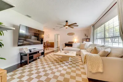 a living room with a white couch and a table at Private Outdoor Oasis with Pool Home in Longwood! in Orlando